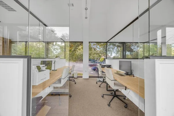 a view of a room with workspace and windows