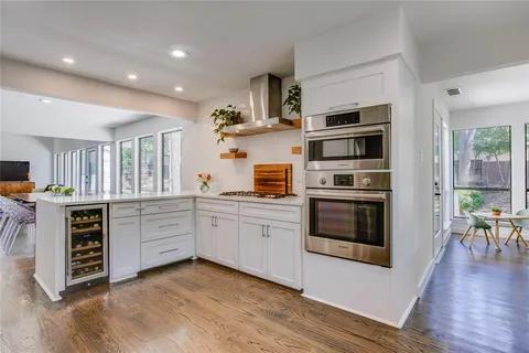 a kitchen with stainless steel appliances a stove sink and cabinets