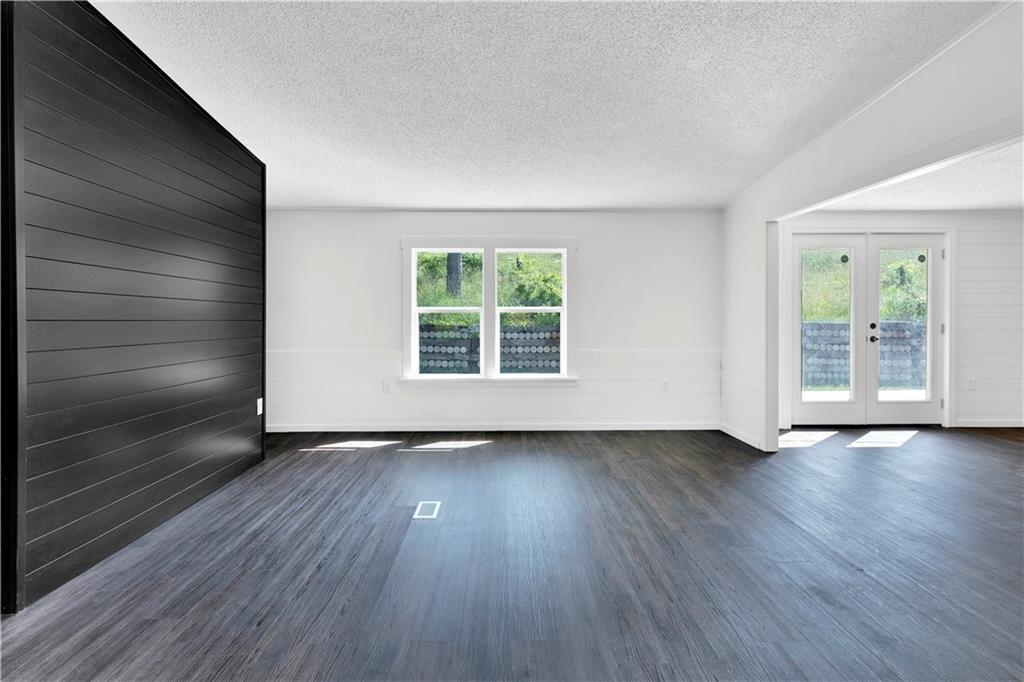910 Dunn Station Road Prosperity, PA 15329 - Photo 5 of 43 a view of an empty room with wooden floor and a window