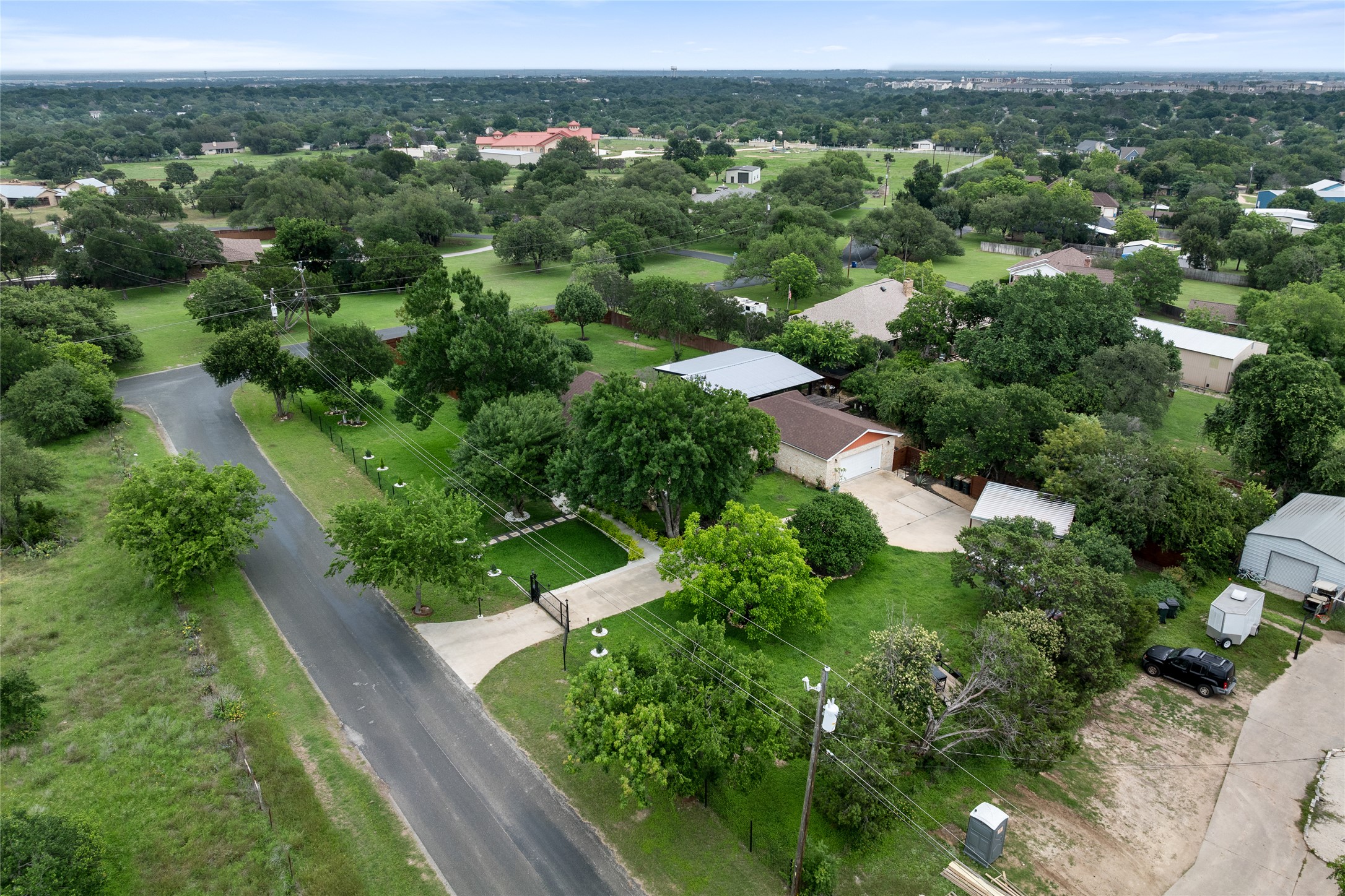 301 Oak Ridge Road Georgetown, TX 78628 - Photo 33 of 34 Aerial perspective showcasing a single-story residence with an attached garage, surrounded by mature trees and verdant landscaping