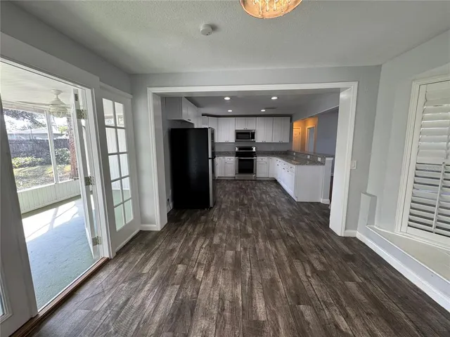 a view of a refrigerator in kitchen and wooden floor