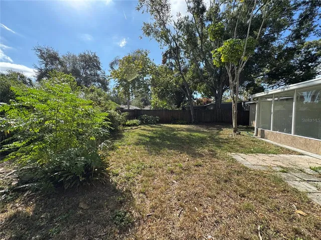 a view of a backyard with large trees