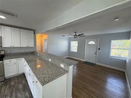 an empty room with window and wooden floor