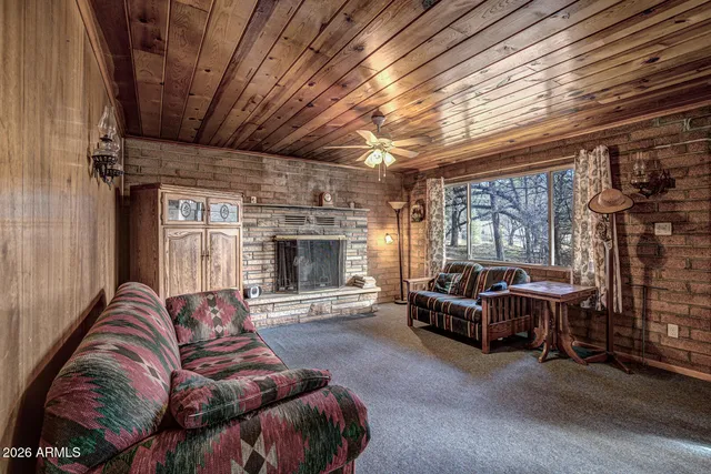 a living room with furniture a flat screen tv and fireplace