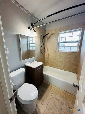 a bathroom with a granite countertop toilet sink and bathtub