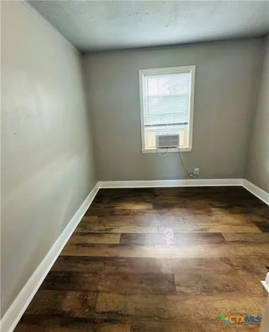 a view of wooden floor and window in a room