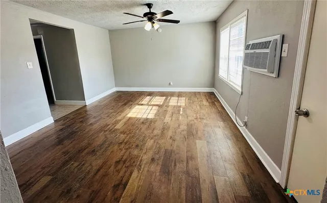 wooden floor in an empty room with a window
