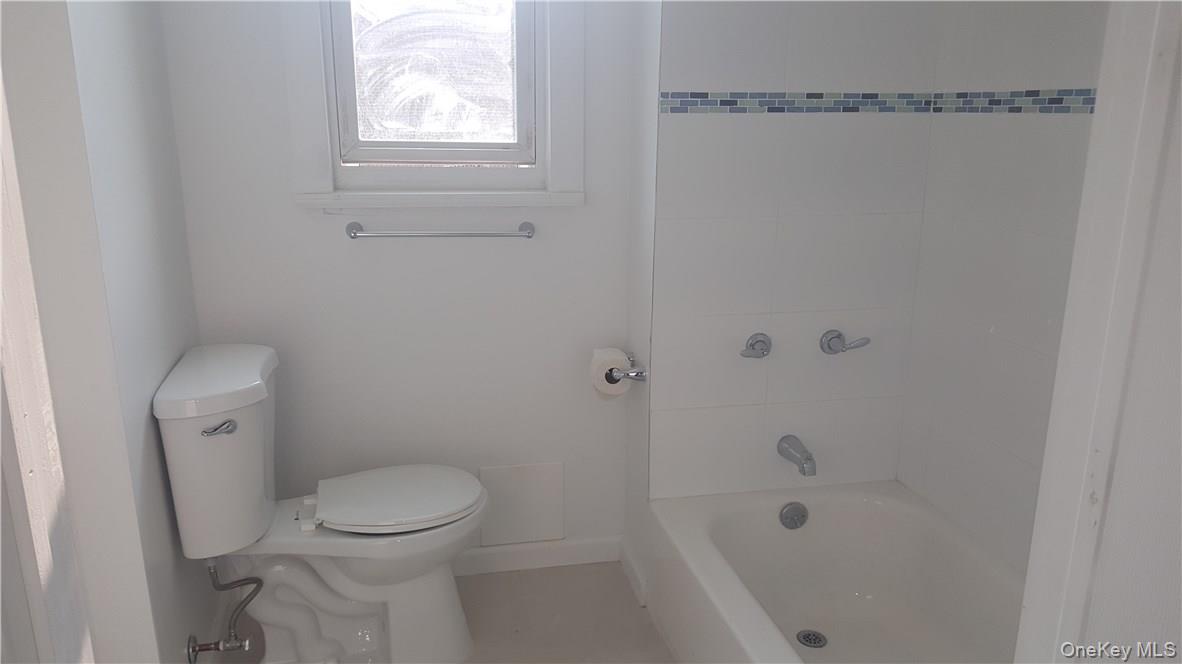 14-16 Horton Avenue, Unit 1 New Rochelle, NY 10801 - Photo 14 of 25 a bathroom with a toilet and shower