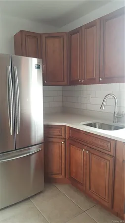 a kitchen with a refrigerator sink and cabinets