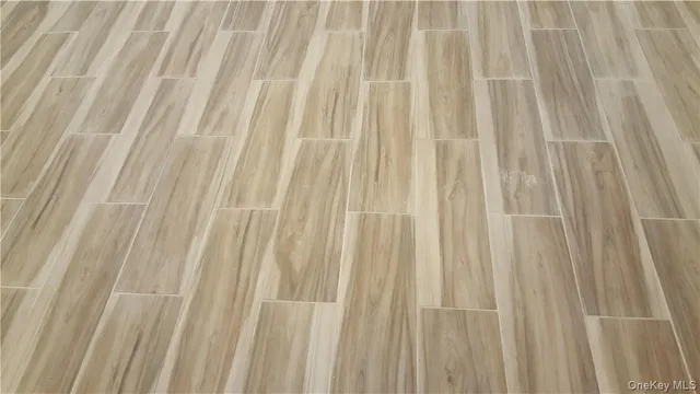 a view of a closet area with wooden floor