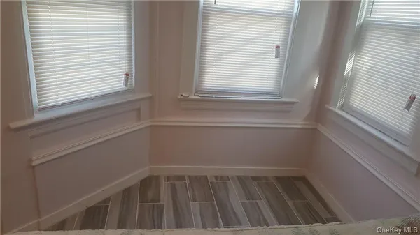 a view of a closet area with wooden floor