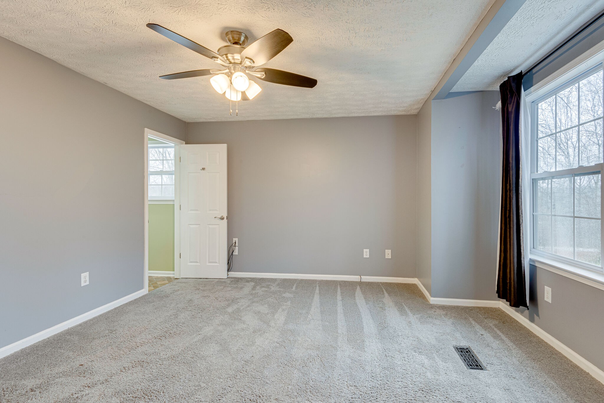 1121 Deer Ridge Road Kingston Springs, TN 37082 - Photo 13 of 27 an empty room with windows and fan