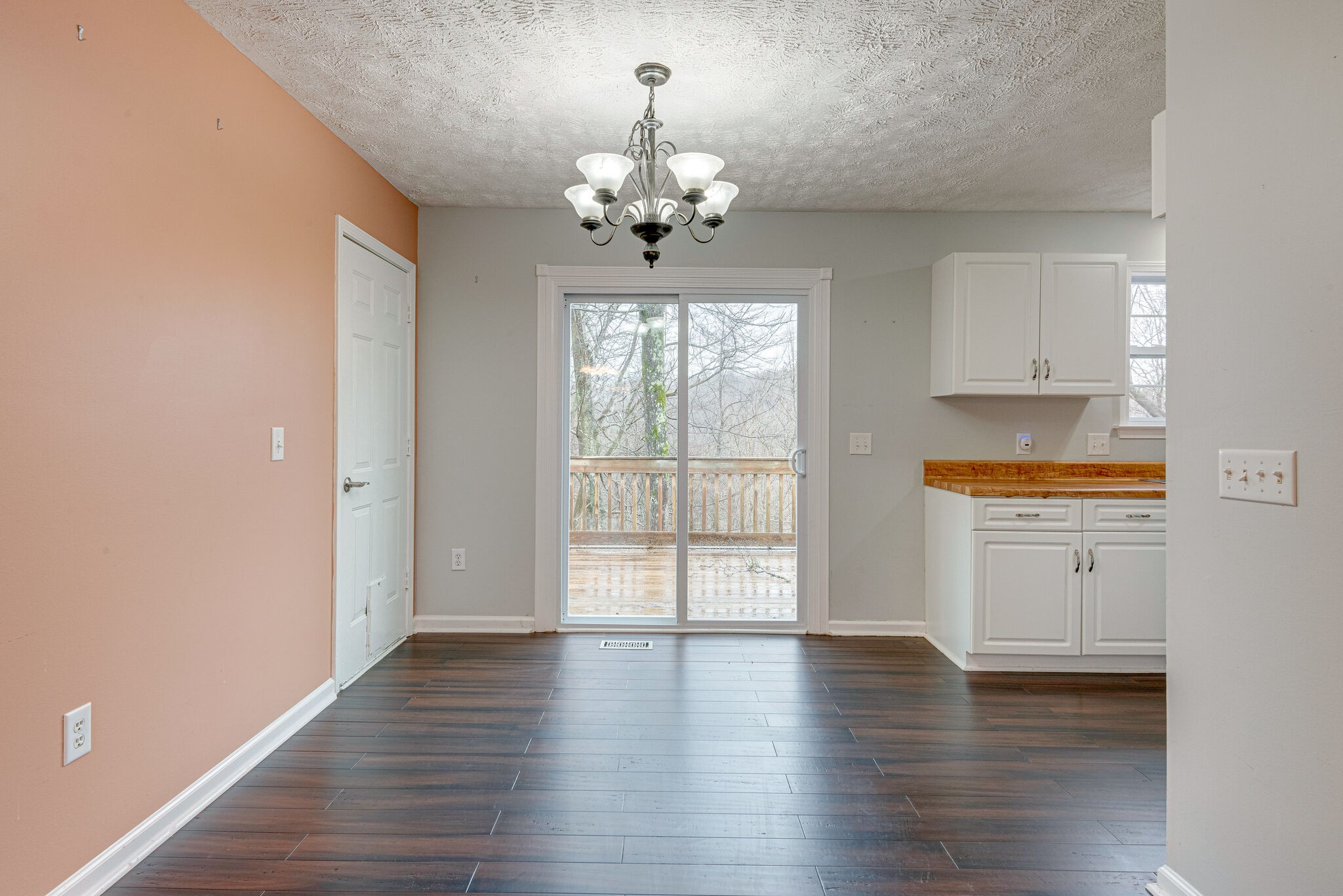 1121 Deer Ridge Road Kingston Springs, TN 37082 - Photo 7 of 27 a hallway with wooden floors and chandelier