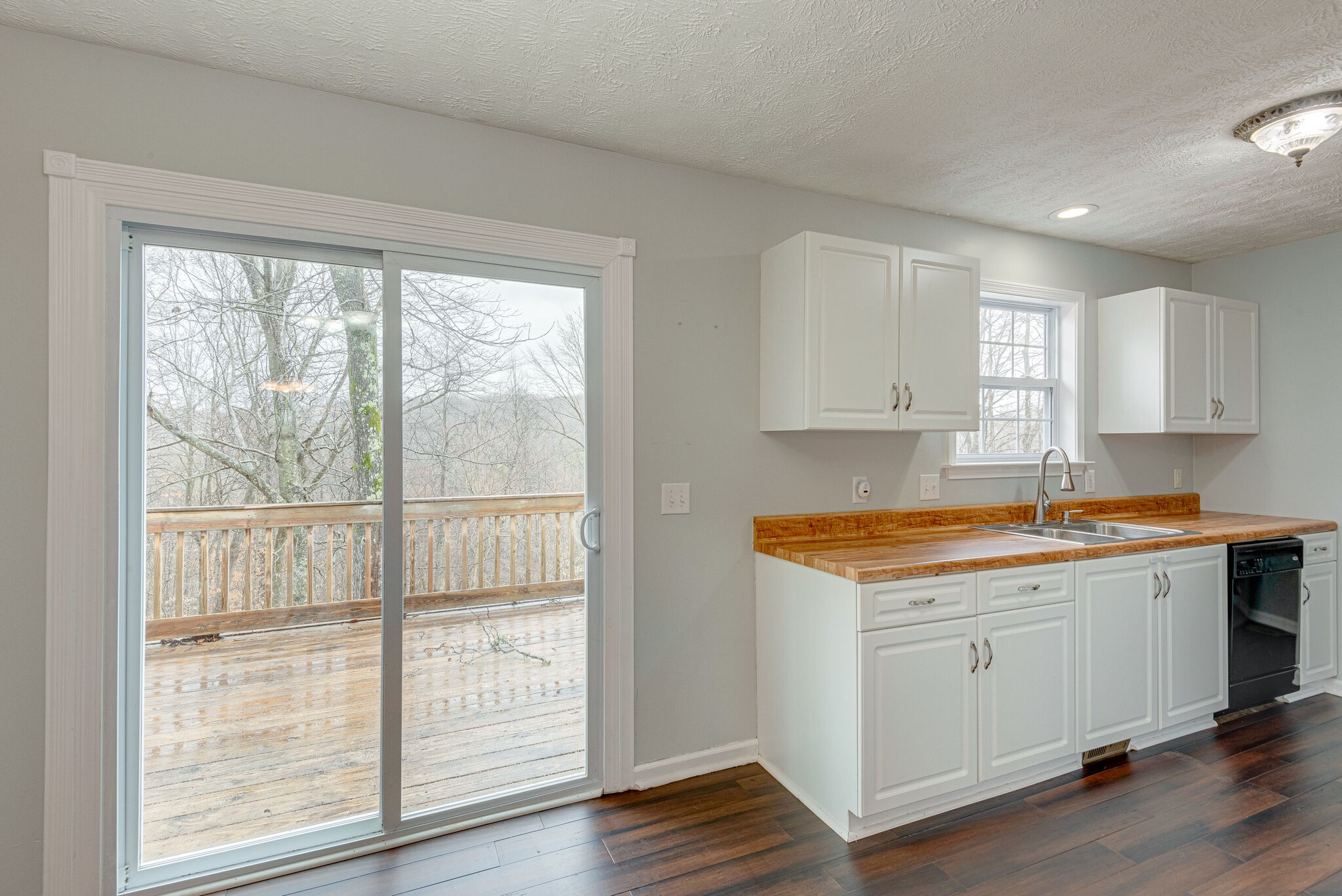 1121 Deer Ridge Road Kingston Springs, TN 37082 - Photo 9 of 27 a view of a kitchen with wooden floor and a window