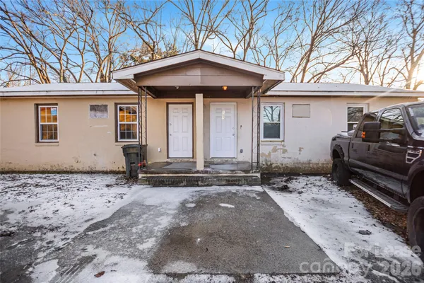 a front view of a house with parking space