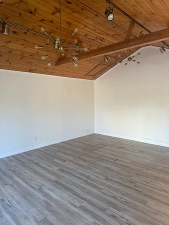 a view of a room with wooden floor