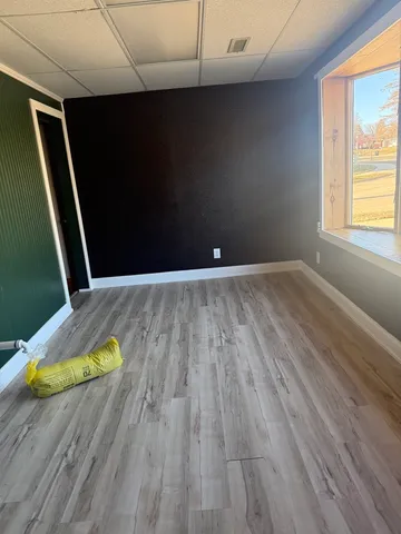 a view of an empty room with wooden floor