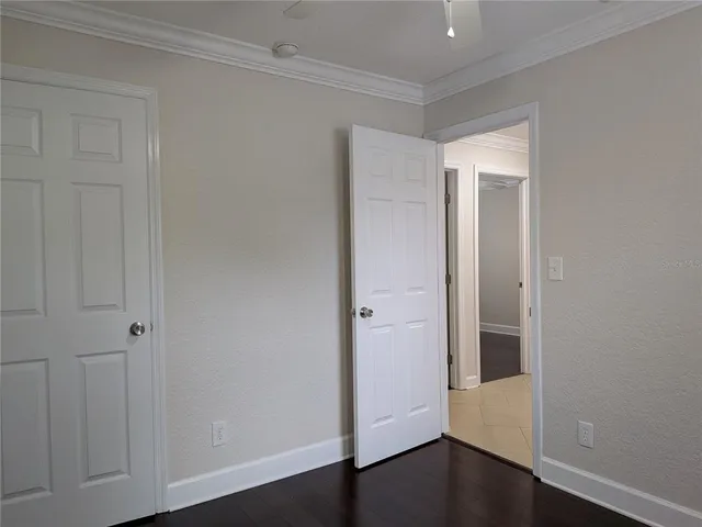 an empty room with closet and windows