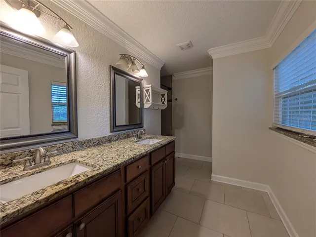 a bathroom with a shower and a ceiling fan