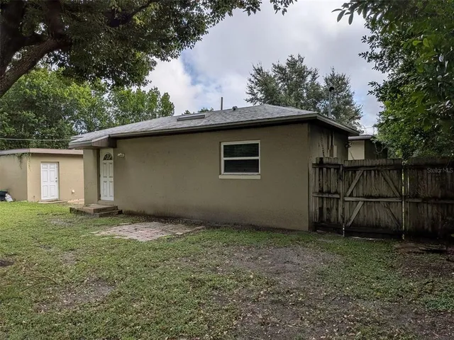a view of a backyard with a tree