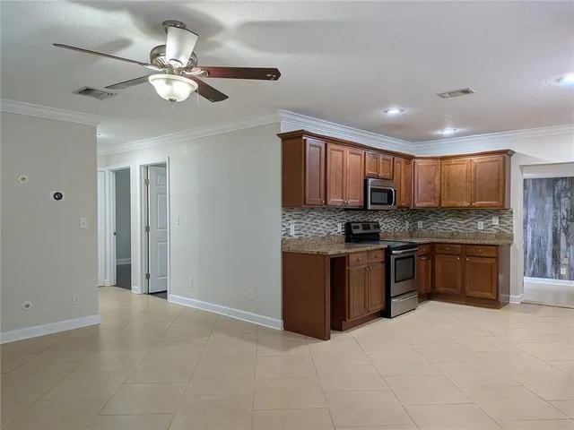 a kitchen with stainless steel appliances granite countertop a stove microwave and sink