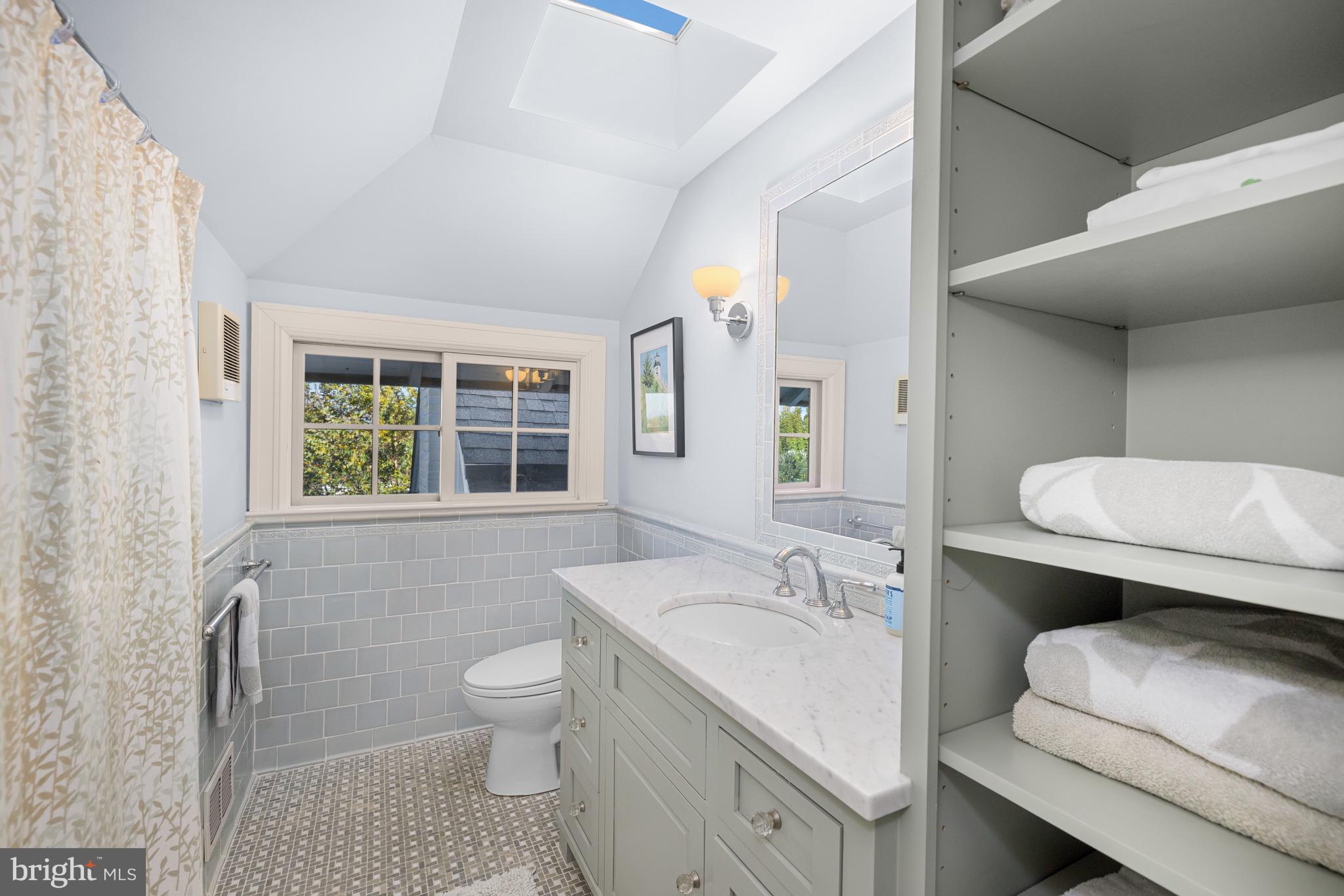 2955 Newark Street Northwest Washington, DC 20008 - Photo 40 of 47 a bathroom with a sink toilet a mirror and bathtub