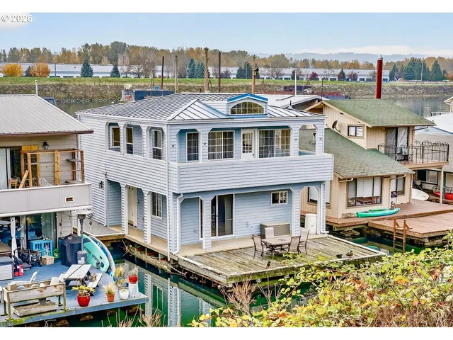 a view of multiple houses with a city view