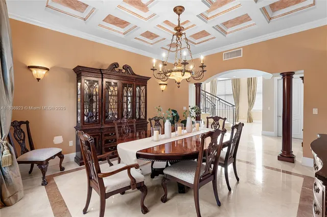 a view of a dining room with furniture and chandelier