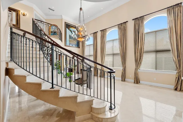 a view of staircase with lots of frames on wall and windows