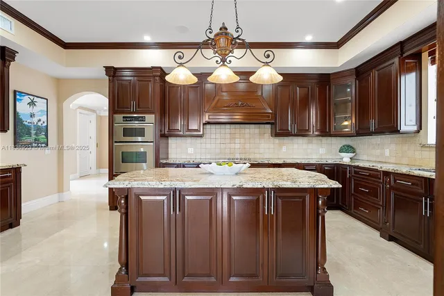 a kitchen with cabinets and wooden floor