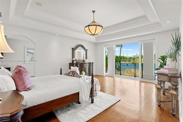 a bedroom with a bed window and table