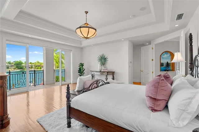 a bedroom with a bed and large windows