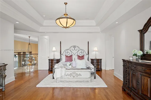 a view of a room with furniture wooden floor and chandelier