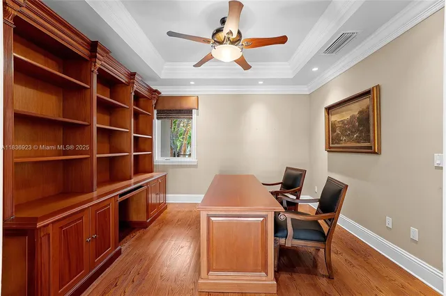 a workspace with wooden floor and windows