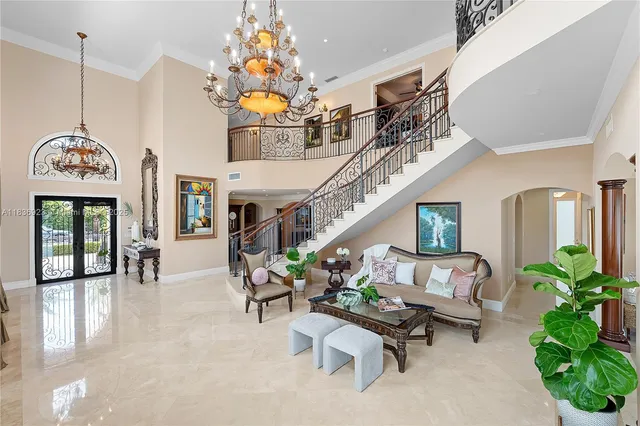 a view of a dining room with furniture a livingroom and chandelier