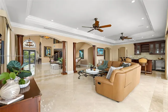 a living room with furniture and a ceiling fan