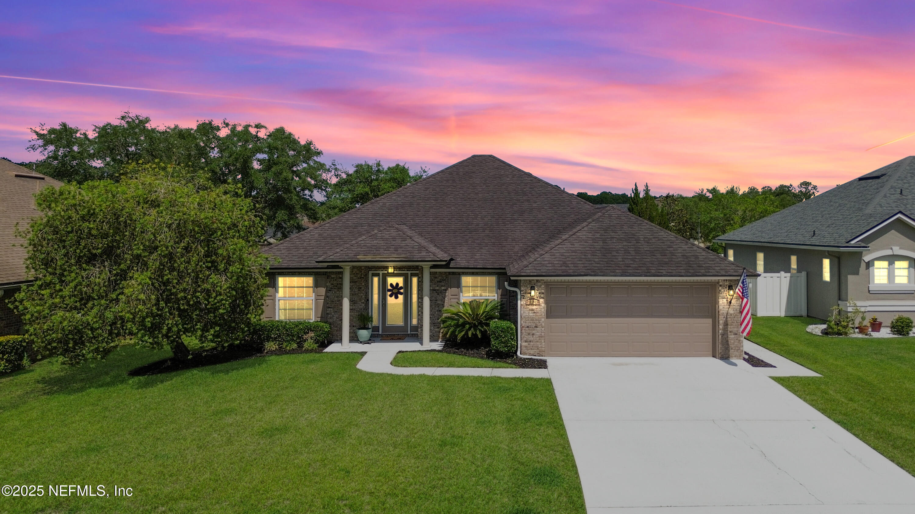 2020 Spring Meadows Court St. Augustine, FL 32092 - Photo 1 of 45 a front view of a house with a garden and yard