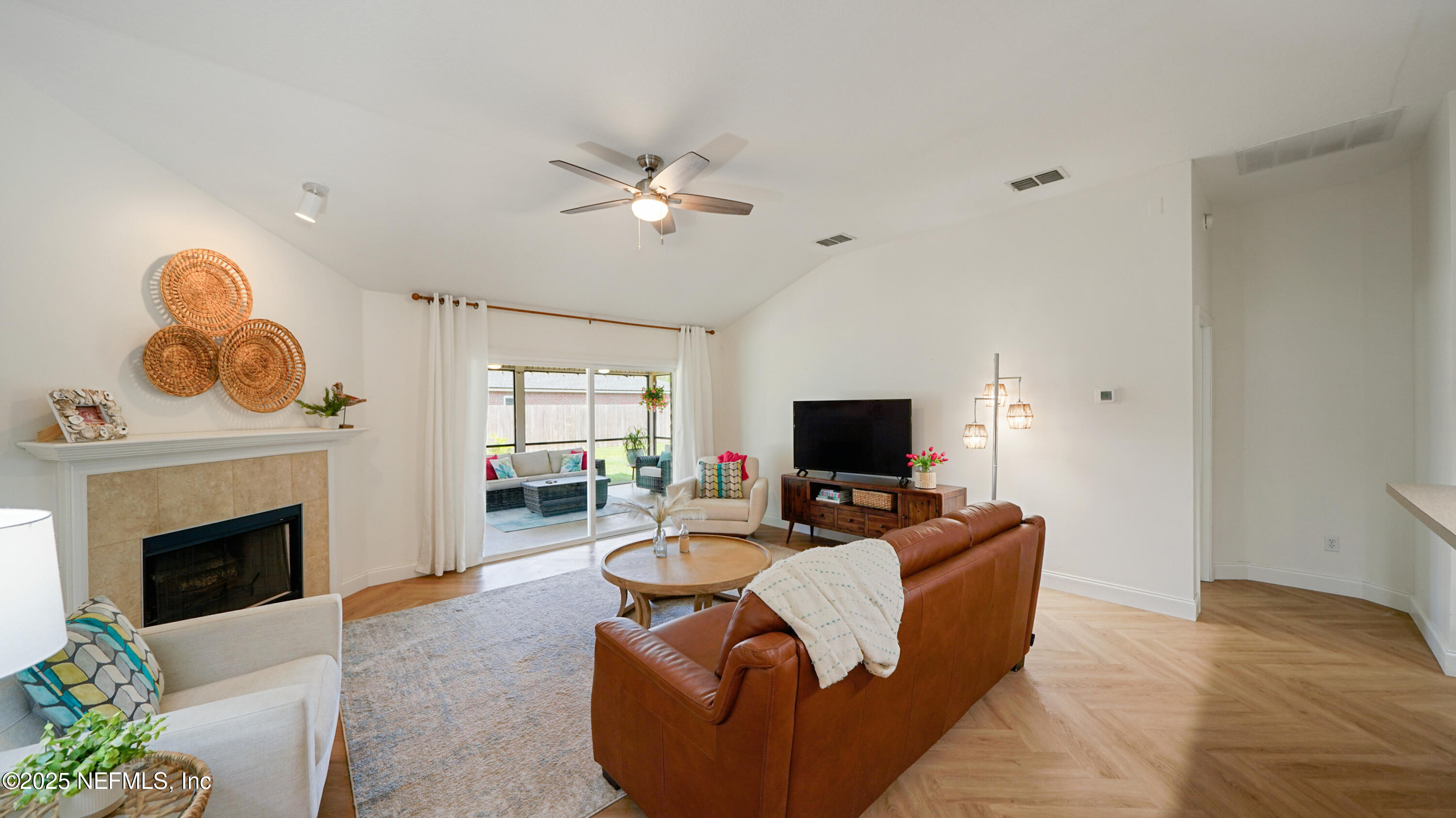 2020 Spring Meadows Court St. Augustine, FL 32092 - Photo 17 of 45 a living room with furniture a fireplace and a flat screen tv