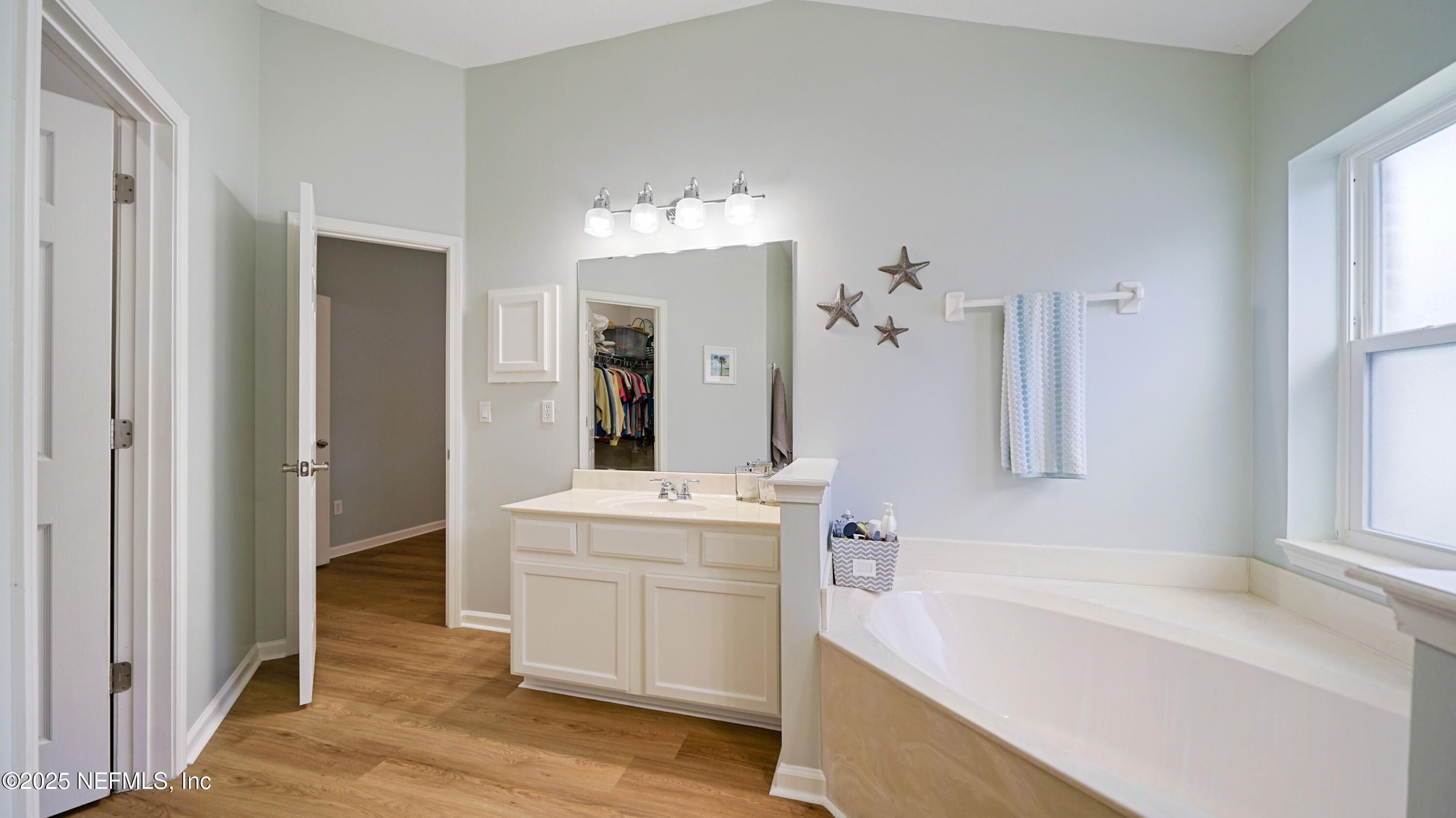 2020 Spring Meadows Court St. Augustine, FL 32092 - Photo 24 of 45 a bathroom with a tub sink and mirror