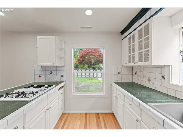 a kitchen with granite countertop a stove and a sink