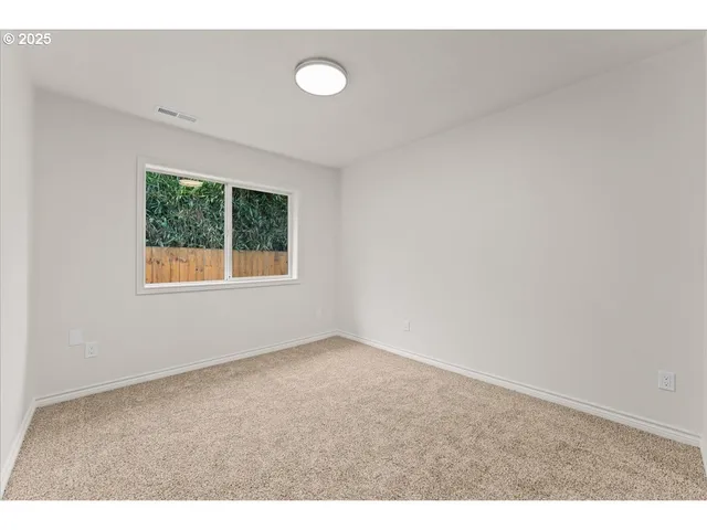 a view of an empty room with windows