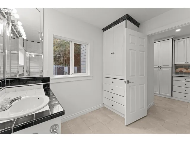 a bathroom with a tub sink and a window