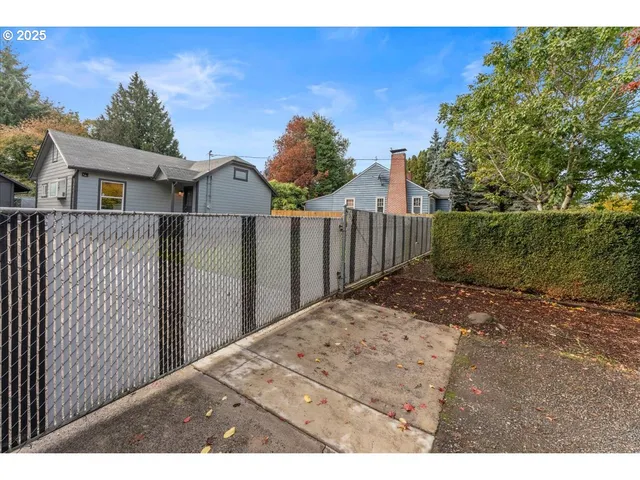 a view of a house with wooden fence