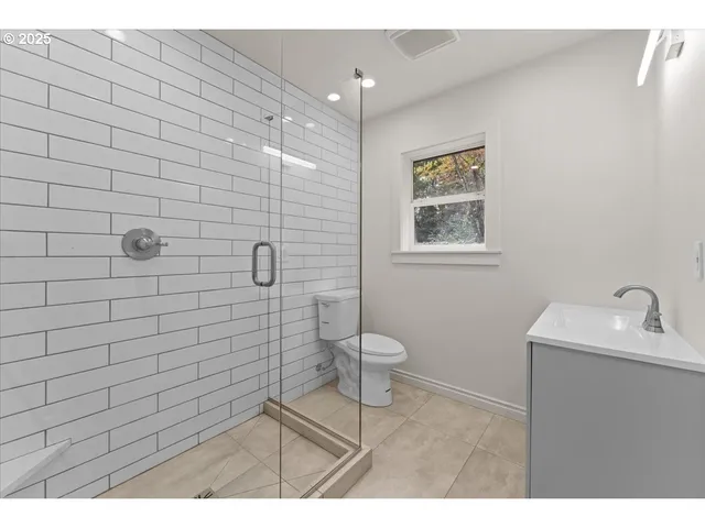 a bathroom with a toilet sink and shower