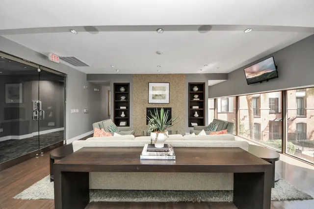 a living room with lots of furniture and a wooden floor