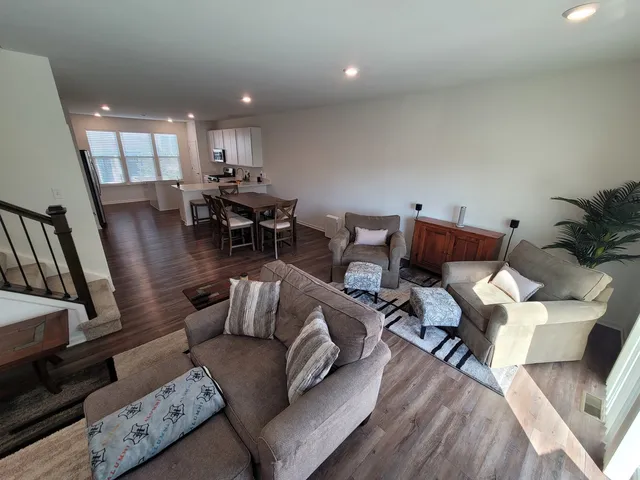 a living room with furniture or wooden floor and a large window