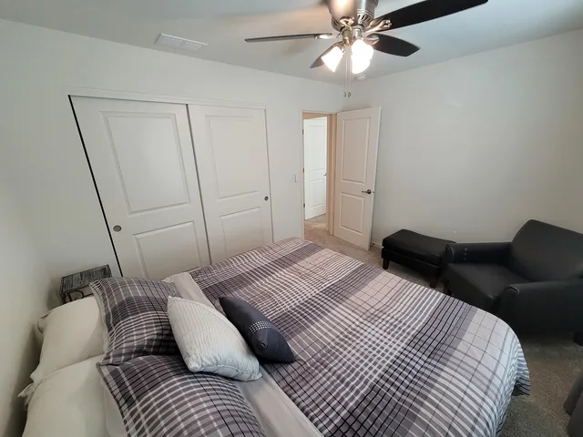a bedroom with a bed and a chair