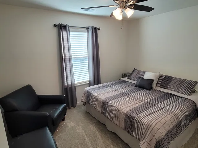 a view of a hallway with couch and closet