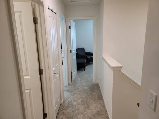 a bedroom with bed and a chandelier