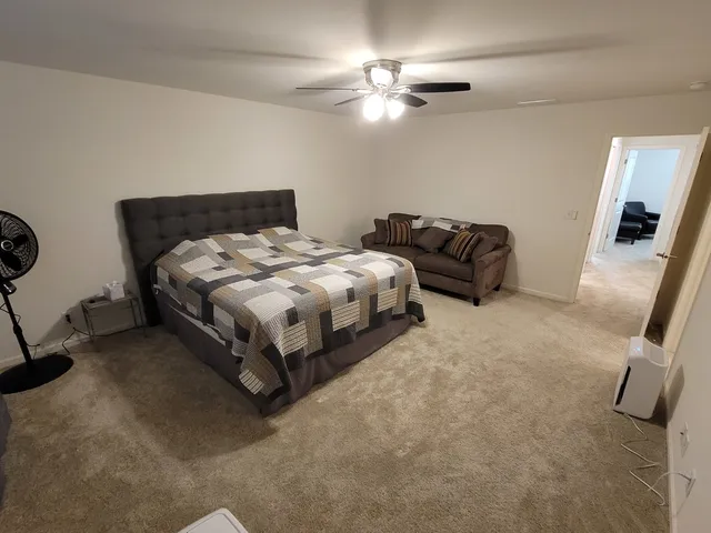 a bedroom with bed and a chandelier